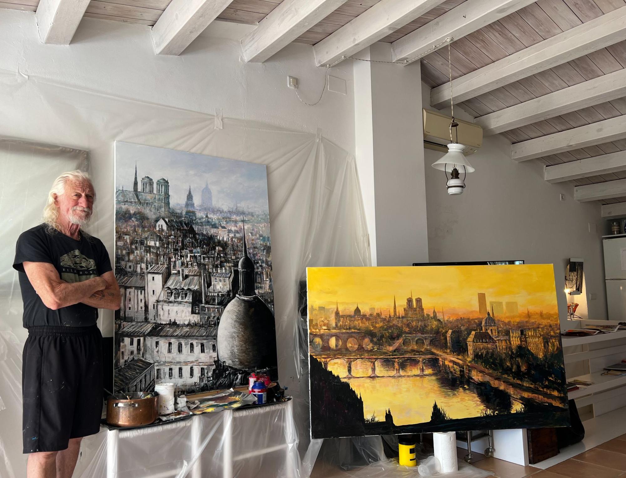 Paul Ygartua in his studio beneath a large portrait painting